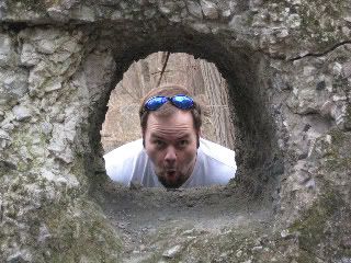 Looking through a hole in a big stone ruin at the park